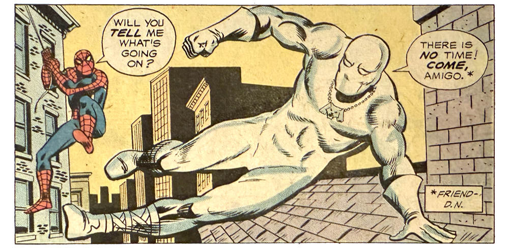 A panel from this issue showing White Tiger hopping across rooftops with Spider-Man swinging on a webline behind him. Spider-Man says, “Will you tell me what’s going on?” White Tiger says, “There is no time! Come, amigo.” An editor’s note explains that amigo means friend.